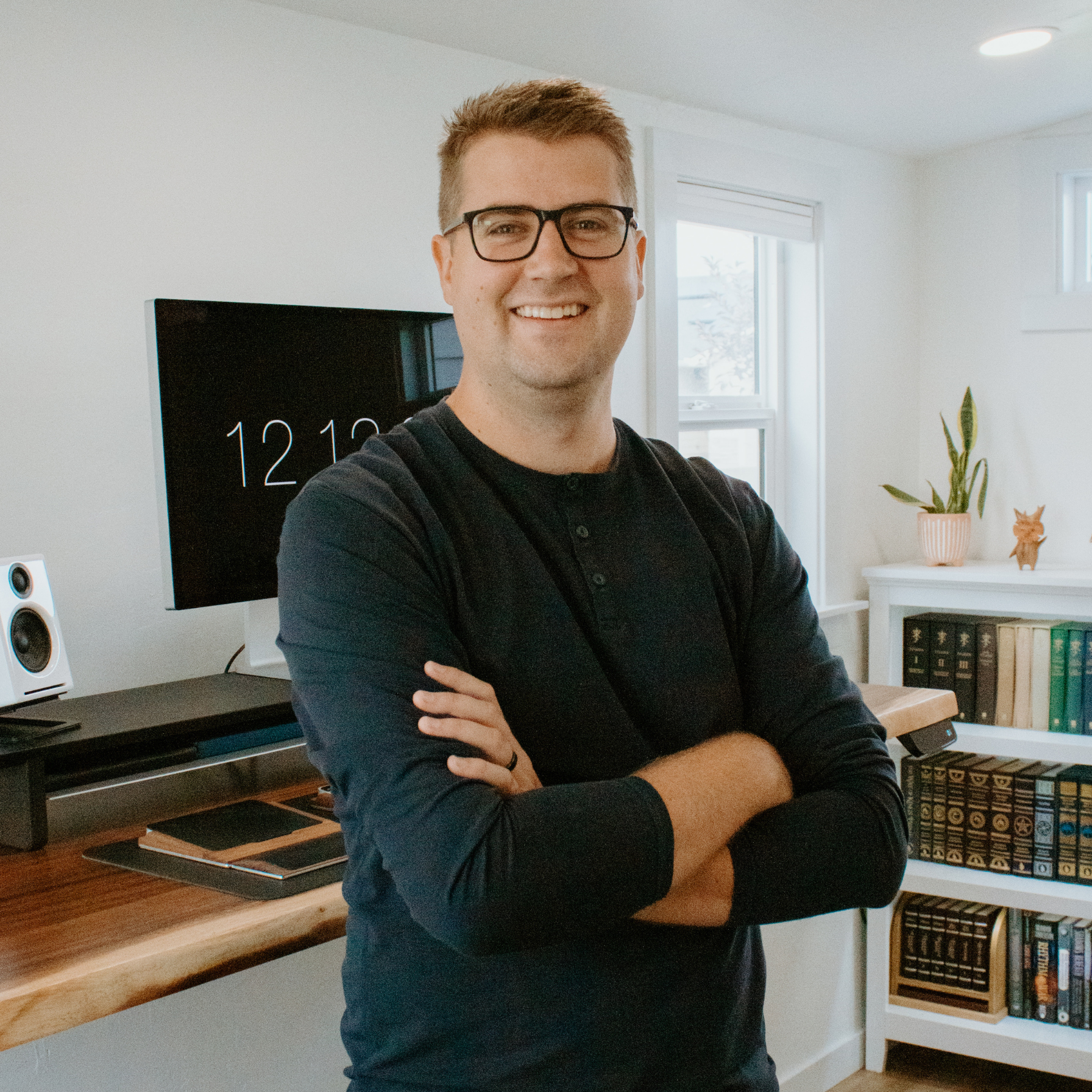 Image of Brian, owner of BrandStack, in his office folding his arms